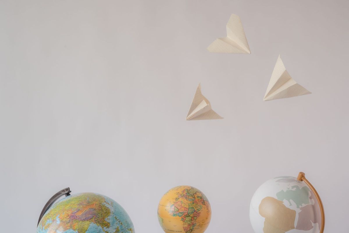 Globes with paper airplanes overhead